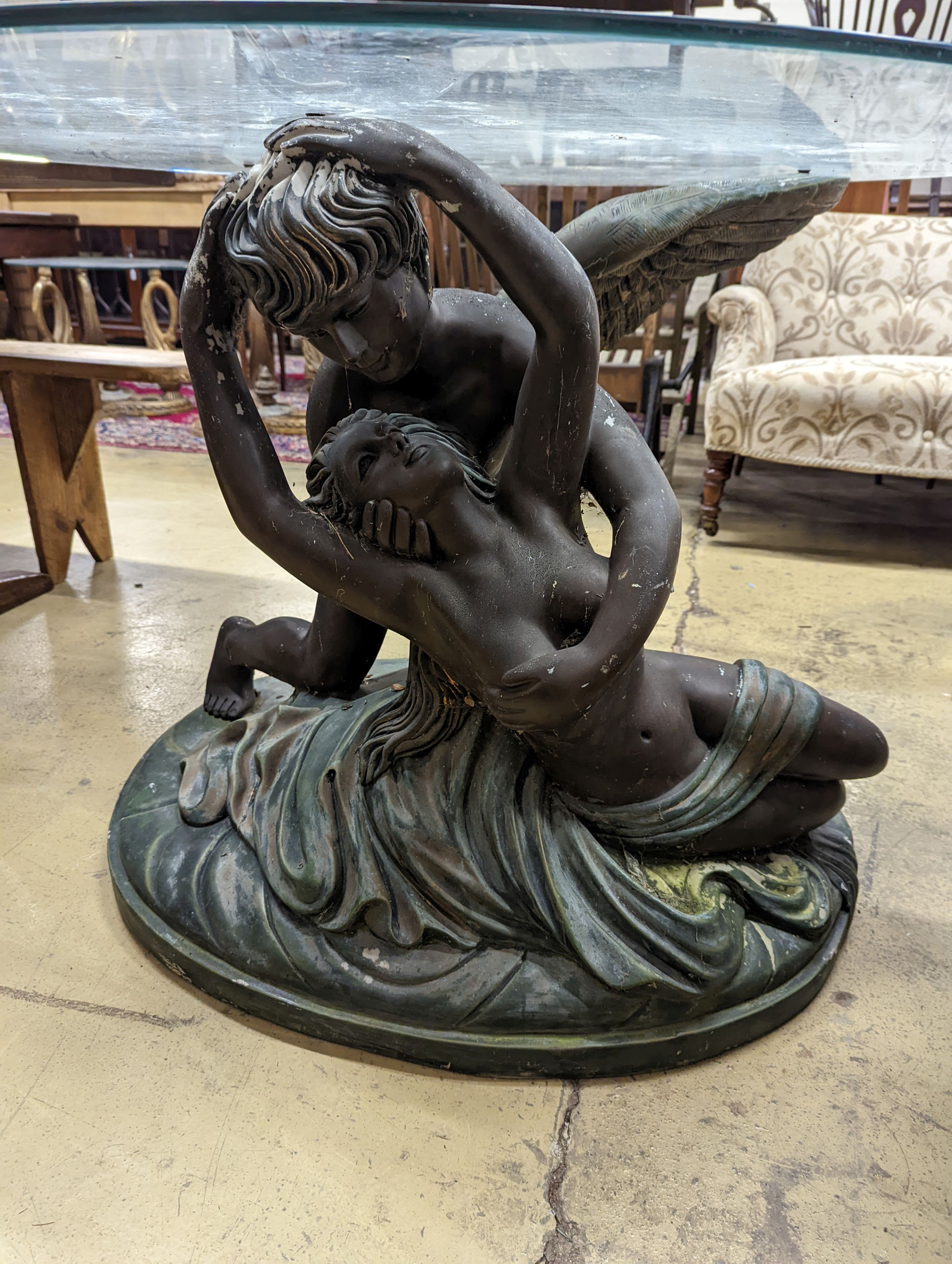 A bronzed composition glass top figures table. Diameter - 122cm, Height - 76cm.